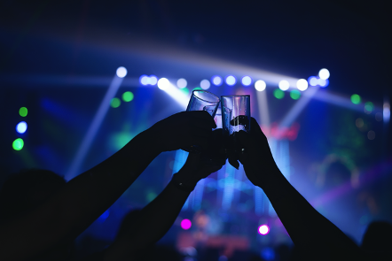 Friends clinking glasses in a nightclub